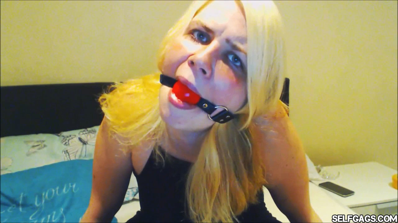 Young blonde girl ball gagged with red ballgag selfgags