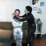 Dominatrix wrapgags young mummified girl
