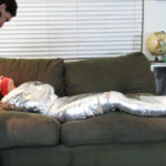 Young girl barefoot in tape mummification bondage