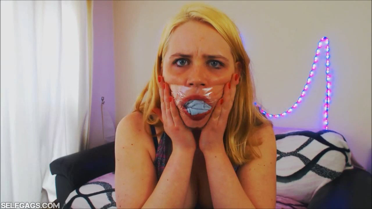 Girl panty gagged behind clear tape gag