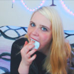 Blonde Anne Dville stuffs a pair of socks in her mouth