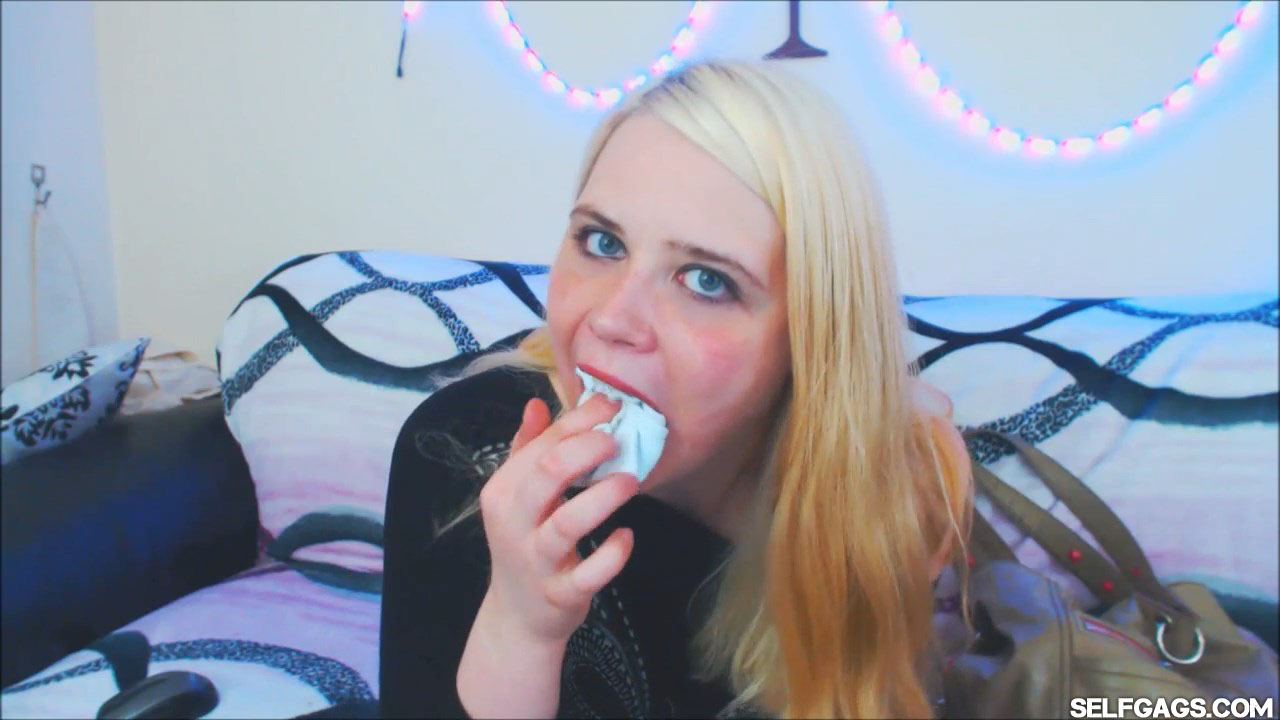 Blonde girl stuffs socks in her mouth at selfgags.com