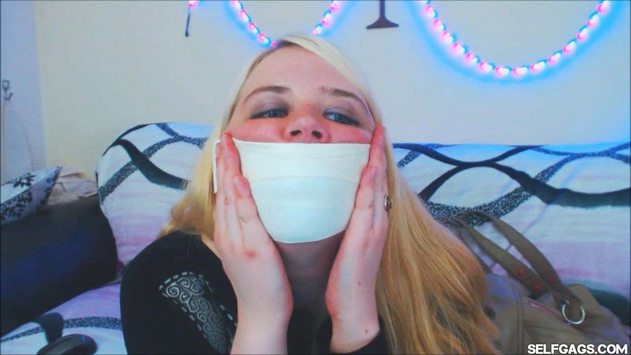 Blonde girl tape gagged with microfoam tape at selfgags.com