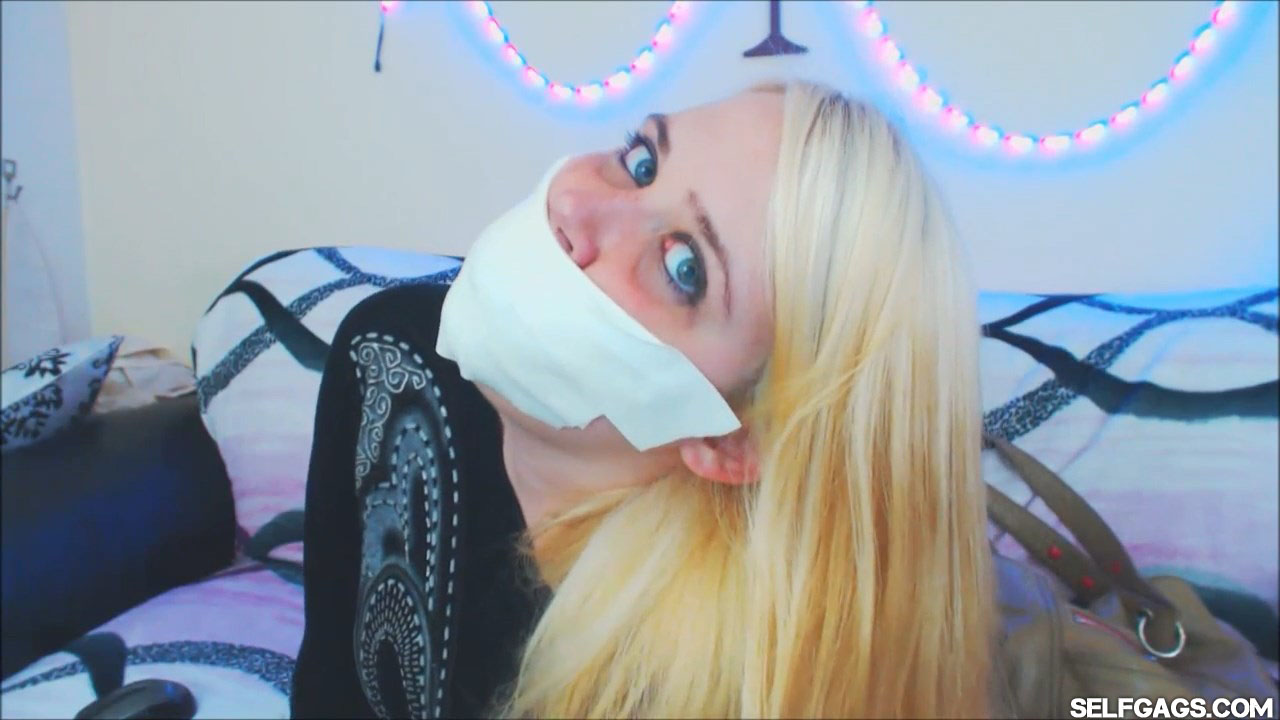Blonde girl gagged with microfoam tape at selfgags.com