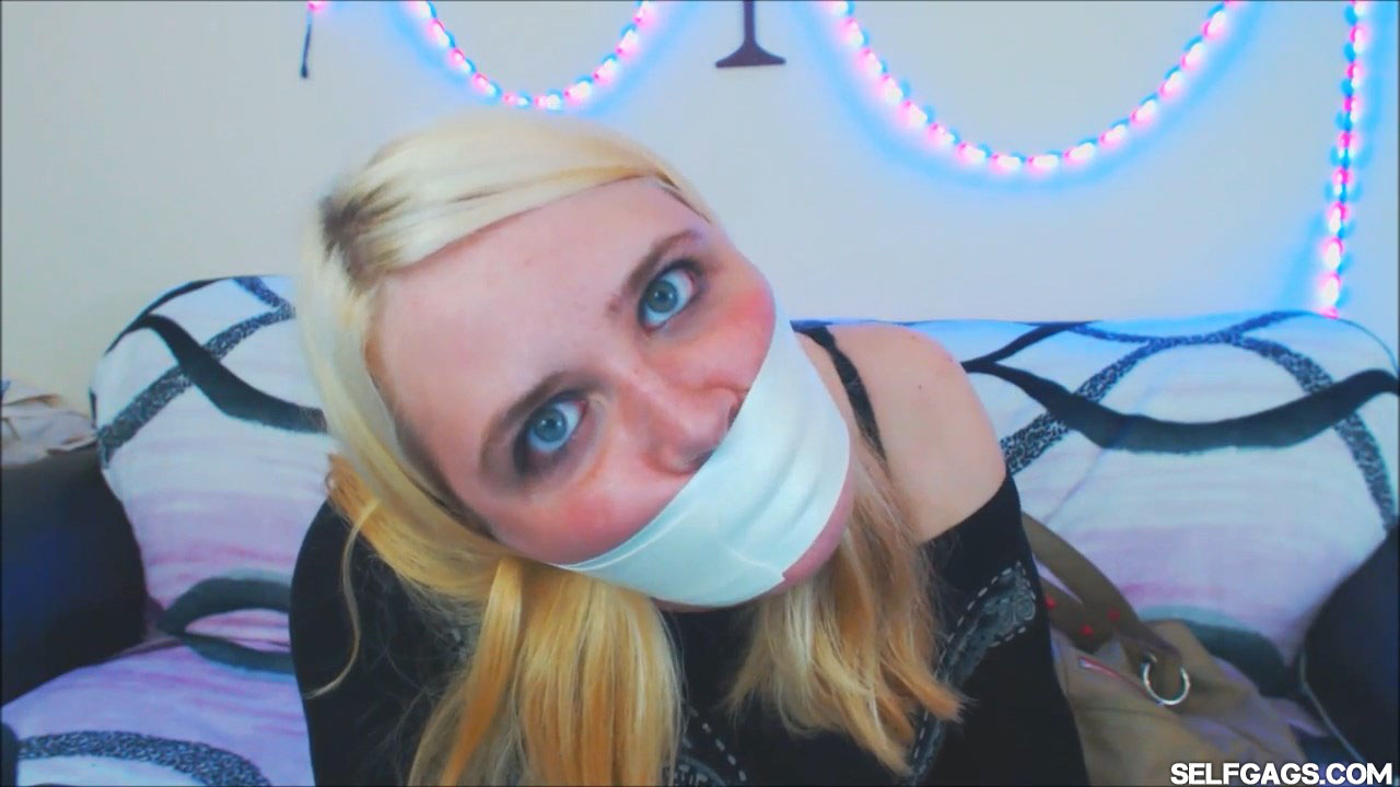 Blonde girl gagged tight with microfoam tape at selfgags.com