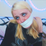 Blonde girl tape gagged tight with microfoam tape at selfgags.com