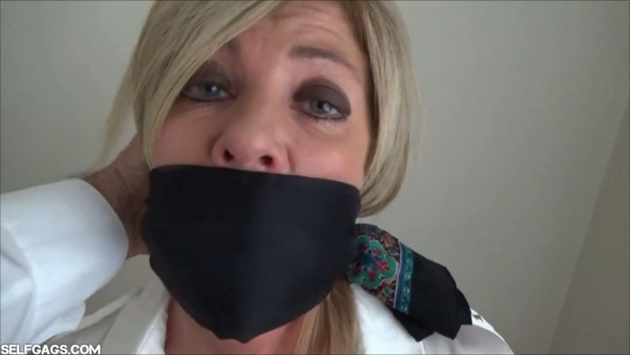 Dakkota Grey over the mouth gagged with a scarf
