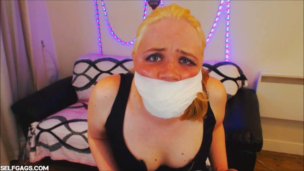 Blonde girl tape gagged tight with cheeks bulging