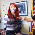 Redhead in tape bondage gagged with duct tape