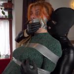 Redheaded girl tape gagged in bondage