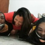 Pantyhose encased hogtied sisters gagged side by side