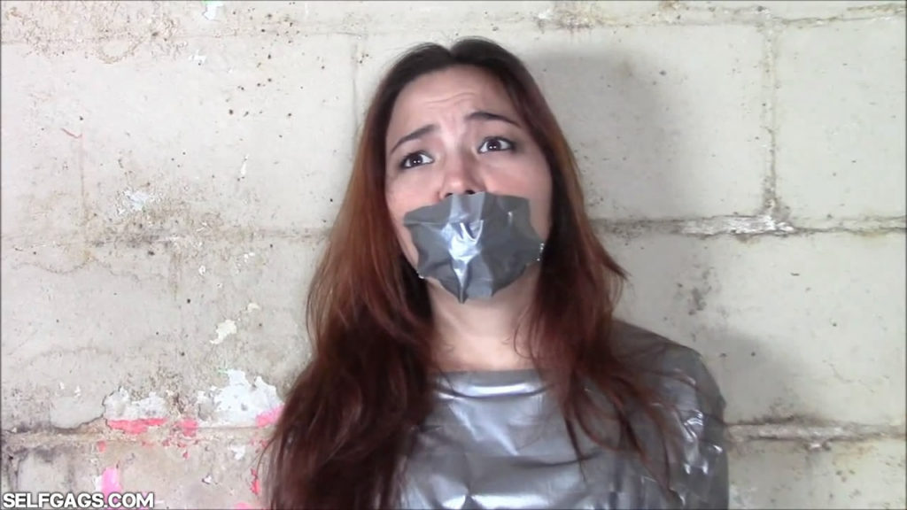 asian american girl gagged with duct tape in mummification bondage