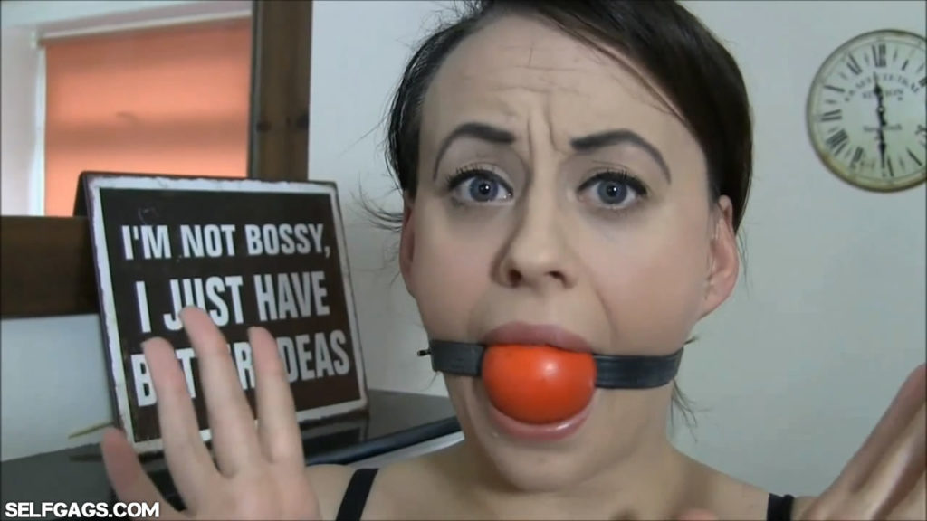 Fetish girl Carleyelle self gagged with big red ballgag