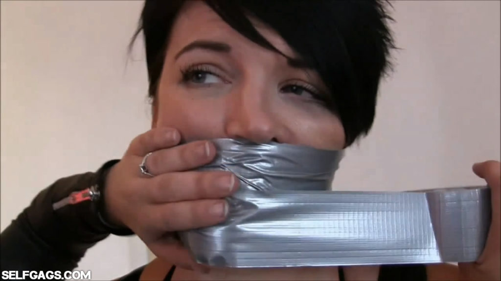 Two sexy women tied up and tape gagged with duct tape by female in leather catsuit