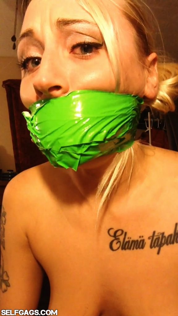 Kinky blonde girl gagged with duct tape wrapped around the head