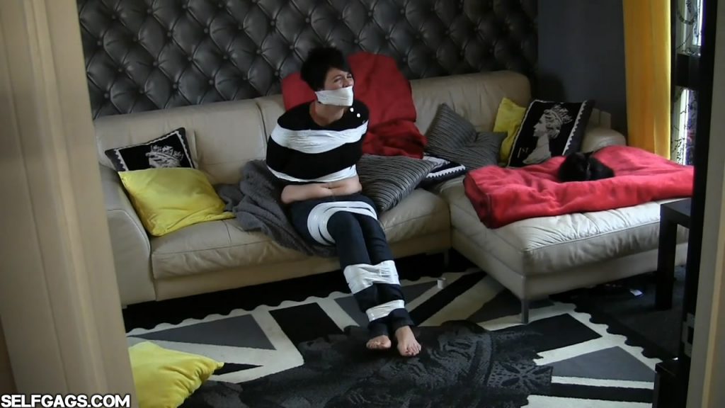 Jet Black bound and gagged in tape bondage