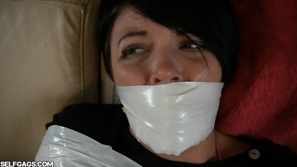 Girl with black hair gagged with white duct tape