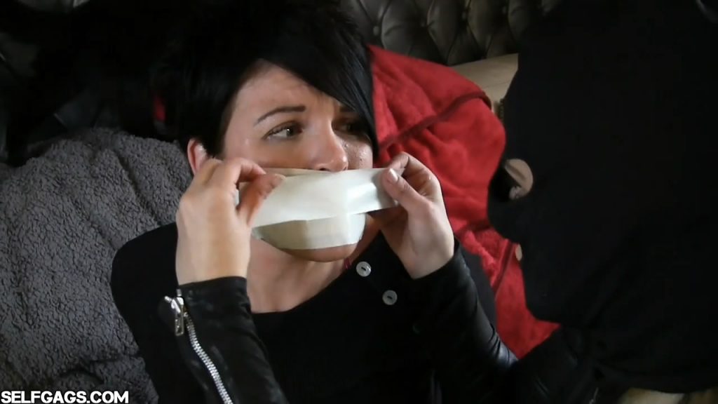 Black haired girl tape gagged by masked woman