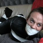 Tape wrap gagged girl in leather catsuit struggles in tape bondage
