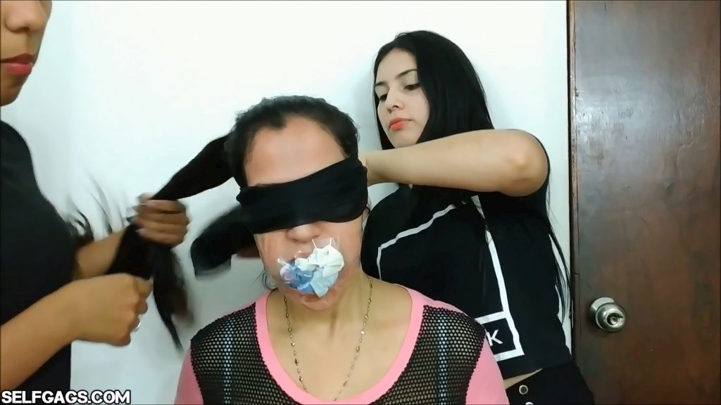Sock mouth stuffed and tape gagged milf blindfolded by her daughters