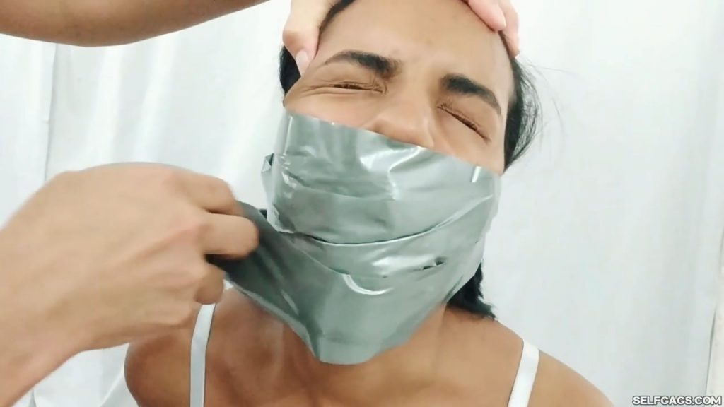 Tape gagged MILF wraps duct tape around young girl's mouth