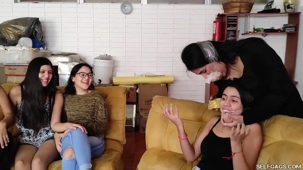 Latina girl has mouth cleave gagged with tape by gagged girl friend