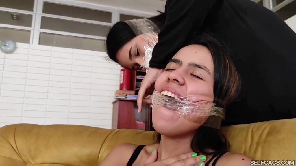 Latina girl has mouth cleave gagged with tape by gagged girl friend