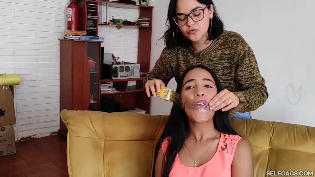 Cute latina girl has mouth taped shut with clear tape wrapgag