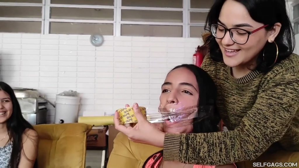 Cute latina girl has mouth taped shut with clear tape wrapgag
