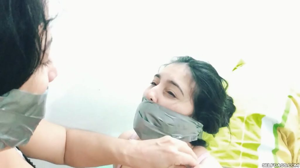 Tape gagged MILF wraps duct tape around young girl's mouth