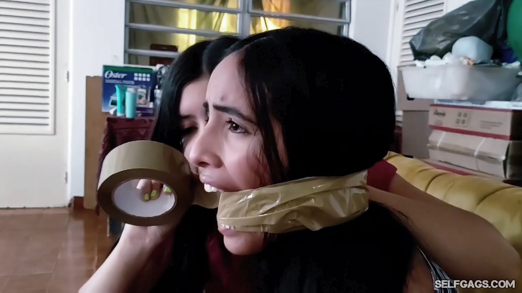 Beautiful bondage girl gets cleave wrap gagged with tape by ruthless latina friend