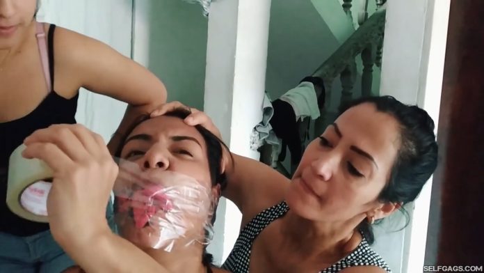 Young latina girl tape bound and panty gagged by mother and daughter