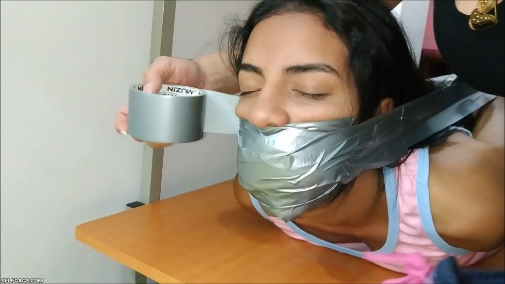 sexy latina babysitter gagged and hogtied barefoot with duct tape on table by milf
