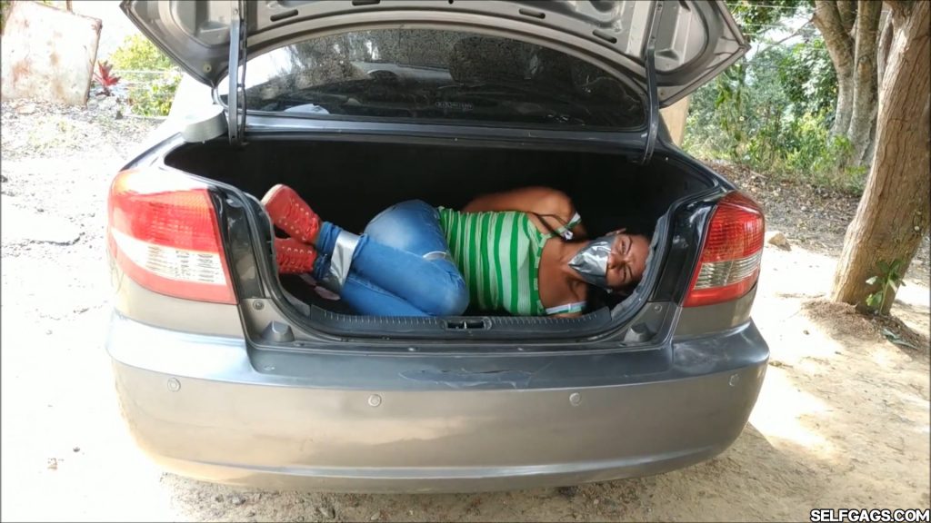 Young latina hitchhiker in jeans gagged for tape bondage in car trunk