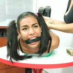 Sexy hogtied teenage bondage girl with pigtails belt gagged on table in high heels