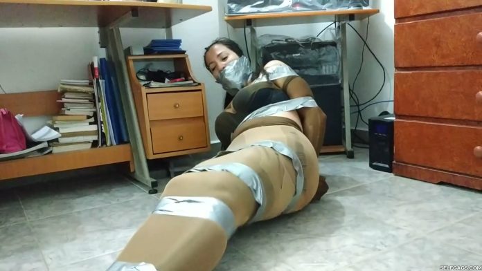 Pantyhose encased babysitter tied up and gagged with duct tape