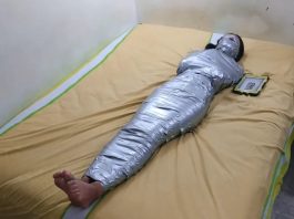 Barefoot girl gagged and blindfolded in mummification bondage