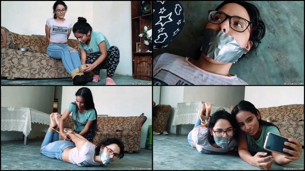 Barefoot girl with glasses hogtied and tape gagged