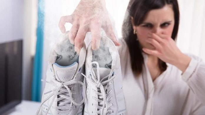 Woman Holding Stinky White Shoes
