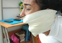 Bound woman wearing microfoam tapegag