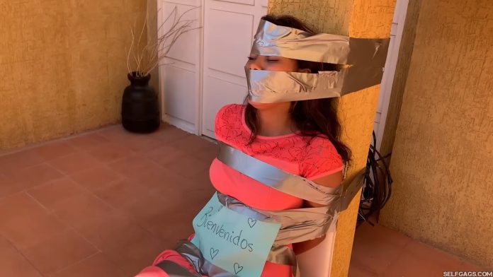 Duct tape gagged girl in outdoor tape bondage