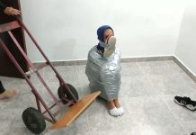 Mummified girl kidnapped by catsuit woman