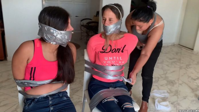 Two girls bound and gagged by woman