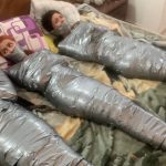 Multiple girls barefoot in mummification bondage