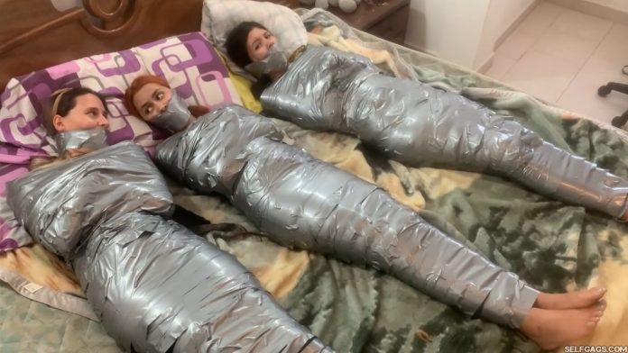 Multiple girls barefoot in mummification bondage
