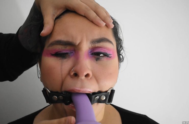 Ring gagged BDSM girl gagging on dildo