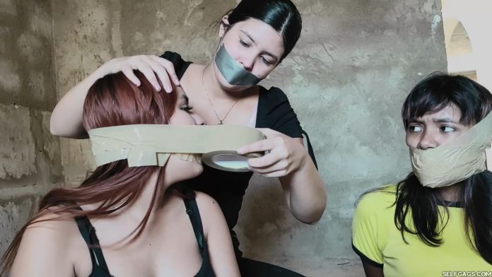 Tape gagged girl gagging other girls