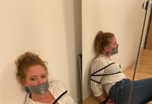 Gagged woman tied up in jeans and boots