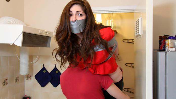 Tape gagged woman carried over the shoulder