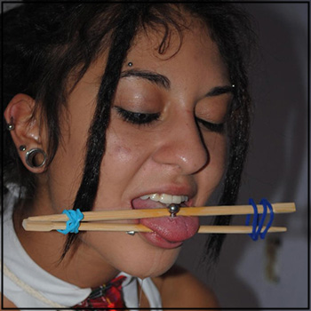 Tongue pierced girl gagged with chopsticks